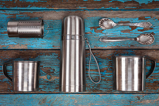 istock Metal thermos, strainer, mugs and spoons. 628799914