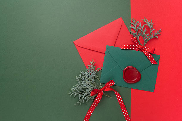 istock Red and green envelopes on christmas holiday background. Flat lay. 628800104