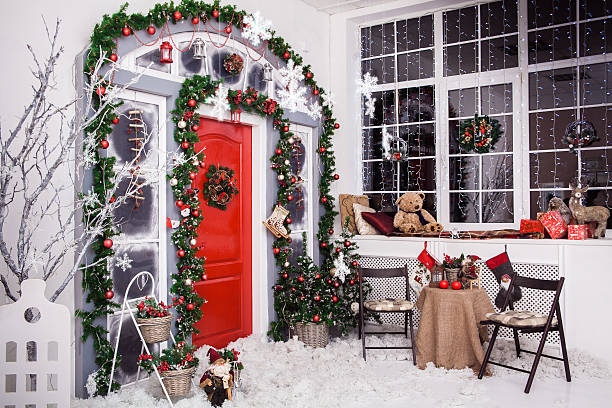istock Winter decoration. Red door with Christmas wreath 628801100