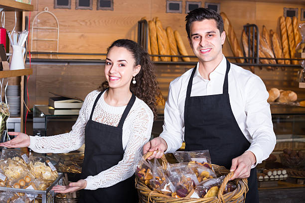 istock Man and woman bakers in bakery 628801504