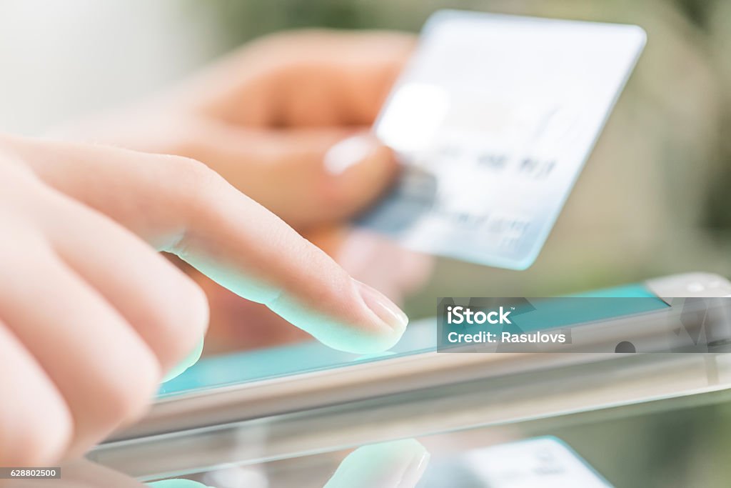 Woman is shopping online using a smartphone. Mobile Payment Stock Photo