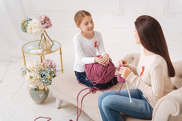 istock Cheerful cute mother and daughter knitting together 628802820