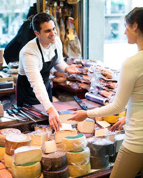 istock Portrait of seller offering different cheese 628803006