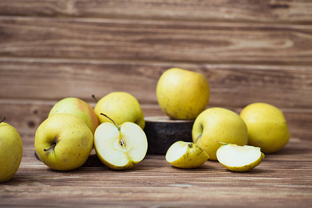istock Golden ripe apples on a wooden background 628803538