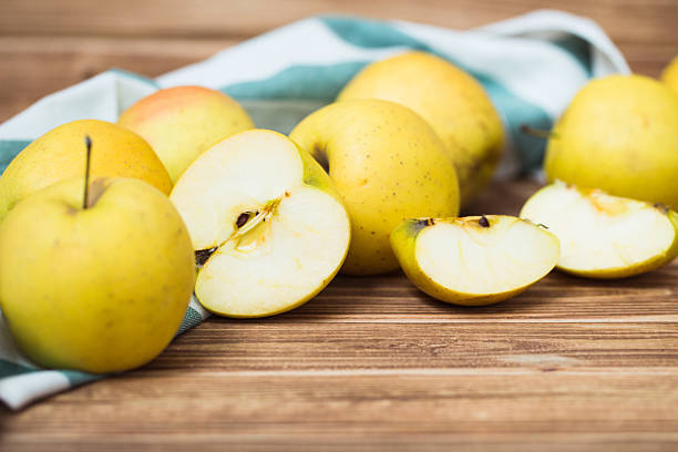 istock Golden ripe apples on a wooden background 628803600