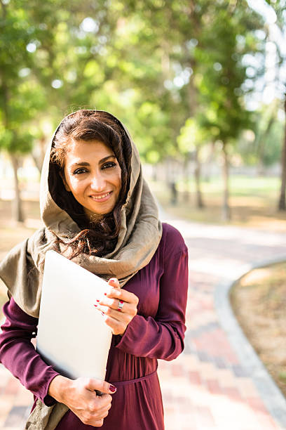 istock arabic woman in the park in abu dhabi - uae 628804046