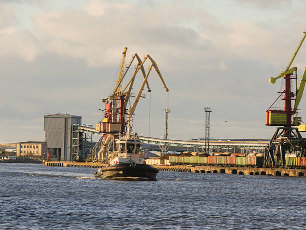 istock Tugboat entering port on full speed. Industrial landscape 628804484