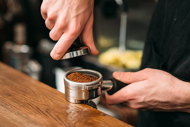 istock Closeup of male hands making coffee. 628811856
