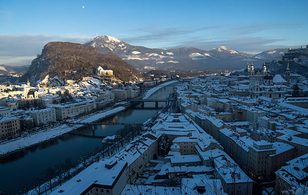 Roofs with snow, overview over Salzburg old town Roofs with snow, overview over Salzburg old town, shortly before sun is setting gaisberg stock pictures, royalty-free photos & images