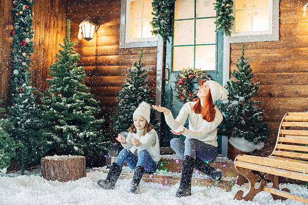 istock Mom and her daughter playing with snow 628812828