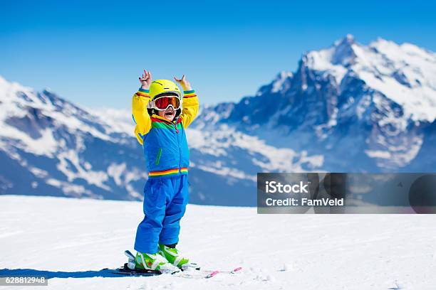 Ski And Snow Fun For Child In Winter Mountains Stock Photo - Download Image Now - Skiing, Child, Family