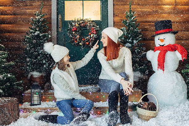 istock Mom and her daughter playing with snow 628813154