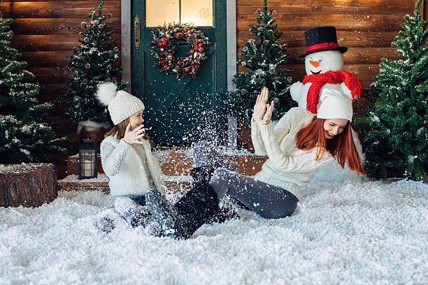 istock Mom and her daughter playing with snow 628813238