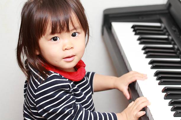 istock Japanese girl playing a piano (2 years old) 628813416