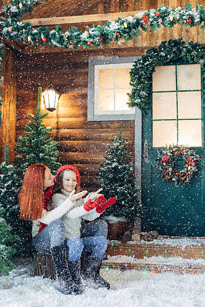 istock Mom and her daughter playing with snow 628813622