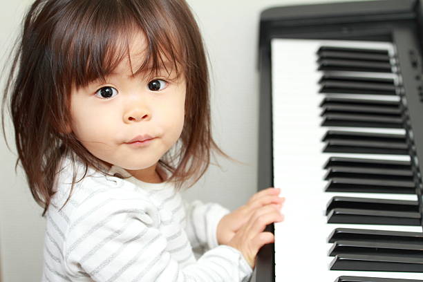 istock Japanese girl playing a piano (2 years old) 628813648