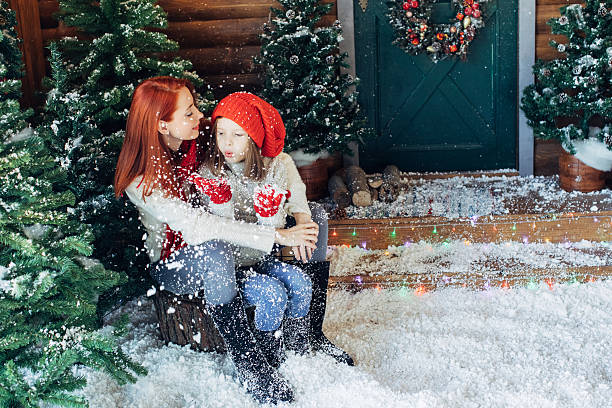istock Mom and her daughter playing with snow 628813716