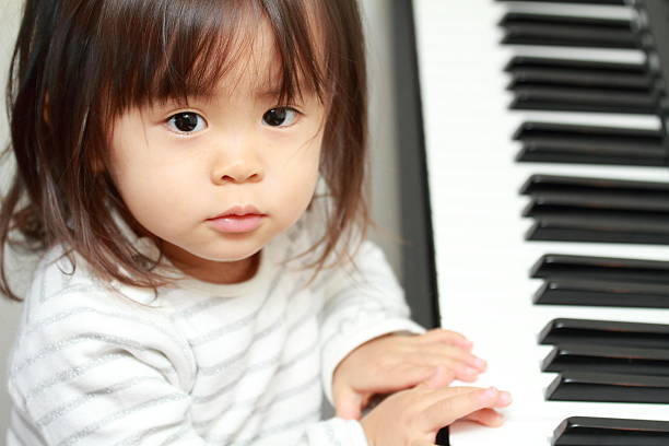 istock Japanese girl playing a piano (2 years old) 628813718