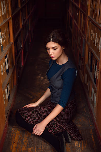 istock University student sitting on a floor of library. 628813920