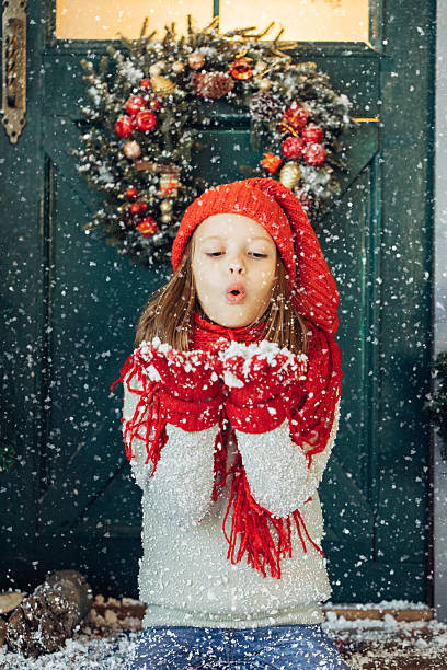 Little girl playing with snow