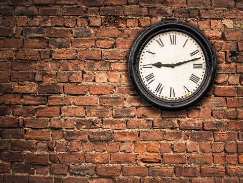 Station Clock On A Red Brick Wall