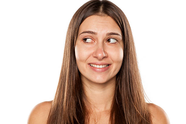 istock Beautiful young woman without makeup and false smile 628817412