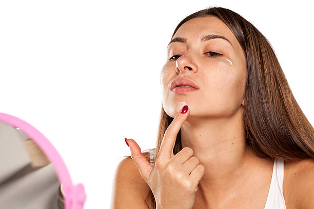 istock young women apply face cream 628818530