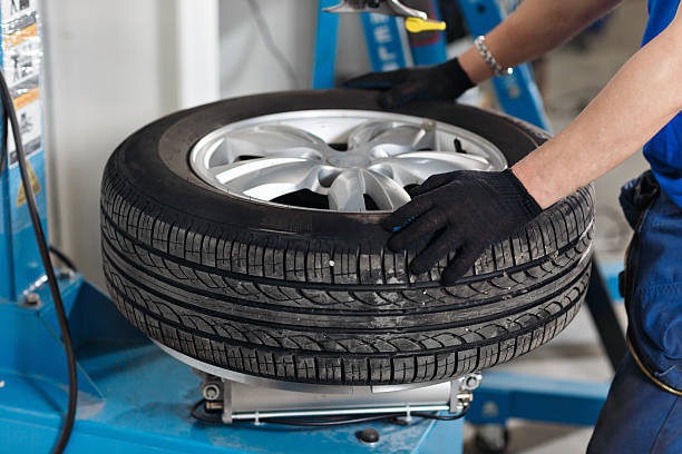 istock Mechanic removes car tire closeup. Machine for removing rubber from 628818656
