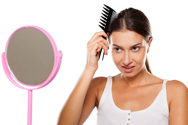 istock young woman combing her hair 628818676
