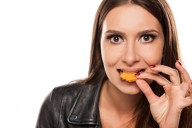 istock young woman eating snacks 628818692