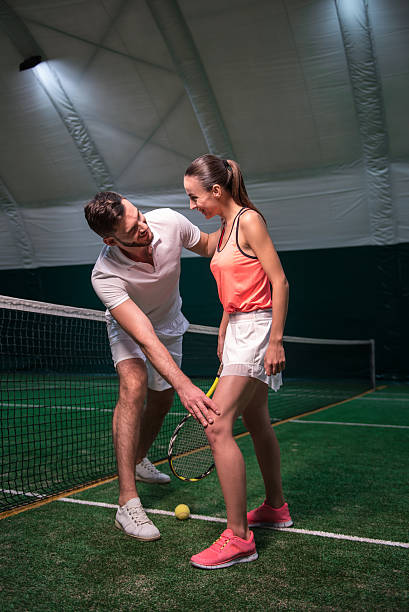 istock Positive friends learning to play tennis 628818962