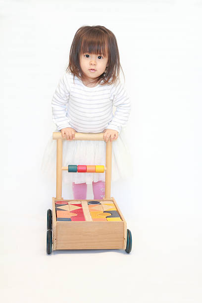 istock Japanese girl pushing a cart (2 years old) 628821372