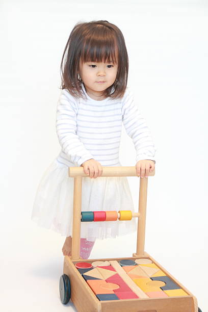 istock Japanese girl pushing a cart (2 years old) 628821398