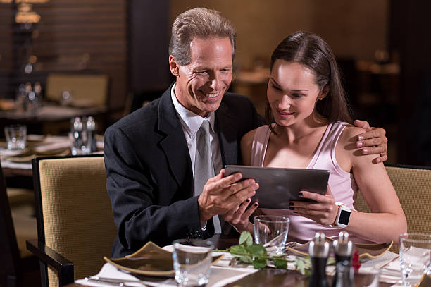 istock Cheerful couple looking at the tablet 628822044