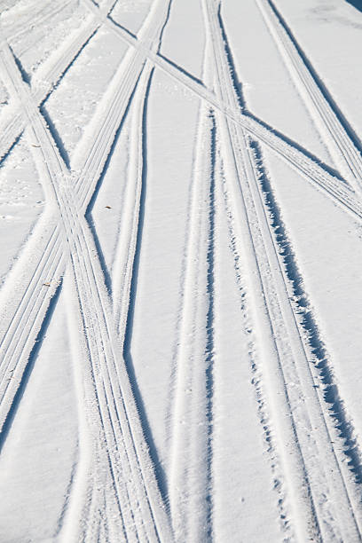 istock Car tire track in snow 628836112