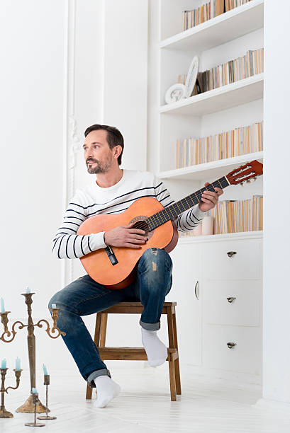 istock Good looking talented man holding the guitar 628840128