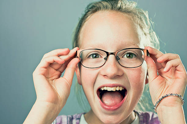 istock Young Girl With Glasses Smiling Funny Face At Camera 628845976