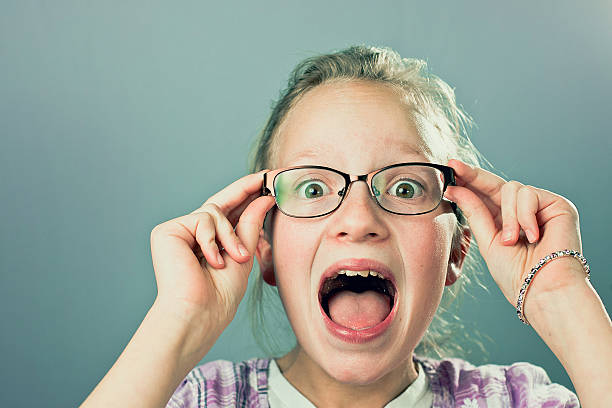 istock Young Girl With Glasses Smiling Funny Face At Camera 628846438