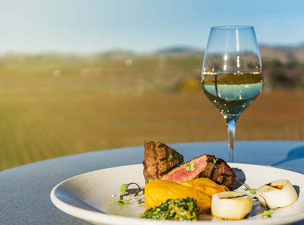 Steak and glass of white wine Steak and glass of white wine at winery marlborough region vineyard chardonnay grape new zealand stock pictures, royalty-free photos & images