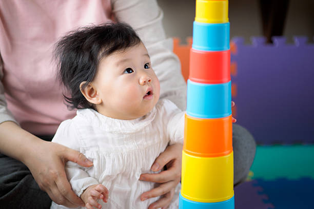 istock Asian baby girl playing stacking cups 628848670