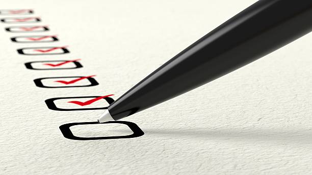 istock Black ball pen crossing off items from a checklist 628855900