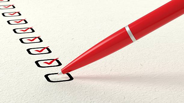 istock Red ball pen crossing off items from a checklist 628856340