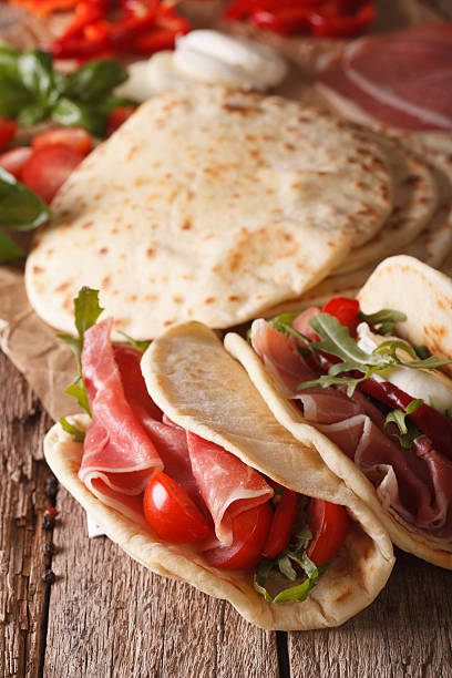 istock Italian piadina flatbread stuffed with ham and vegetables close-up 628856628