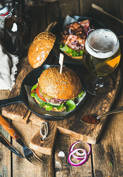 istock Beef burgers with crispy bacon, fresh vegetables and wheat beer 628864268