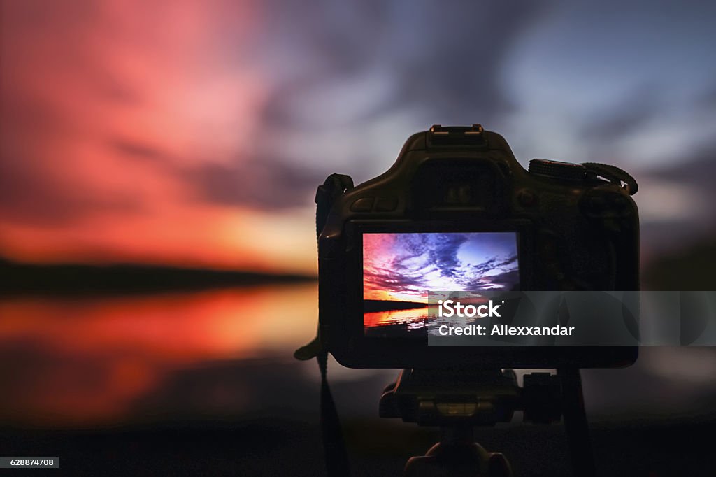 Camera capturing sunset. Photography view landscape. Camera the night view Camera - Photographic Equipment Stock Photo