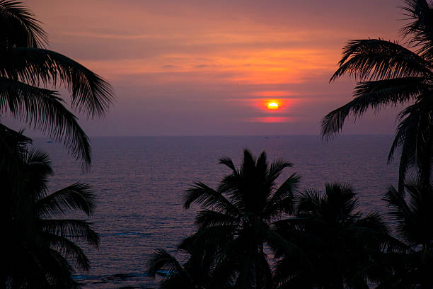 istock Tropical sunset on rock beach, Goa, India 628882976