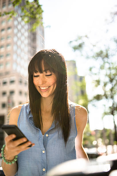 istock woman on the phone sitting in montreal text messaging 628884070