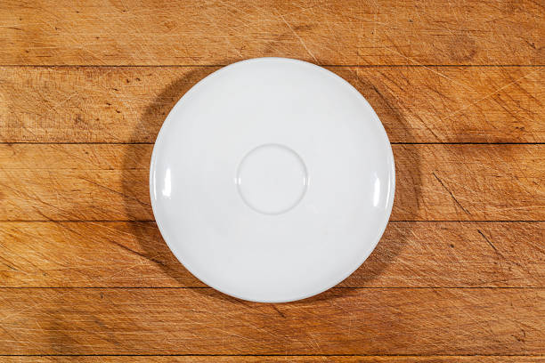 istock Flat white saucer on wooden cutting board from above 628884204