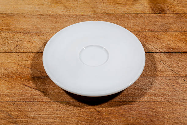 istock Flat white saucer on wooden cutting board from side 628884760
