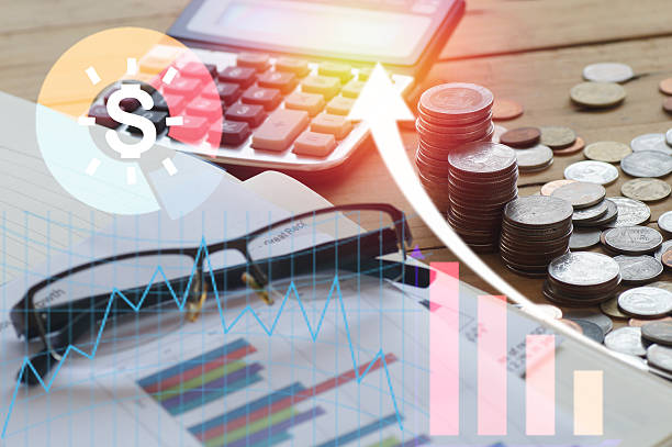 istock pile coin money and calculator with work book 628884808